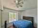 Cozy bedroom with a ceiling fan and a view of the backyard at 1105 Enderly Ln, Las Vegas, NV 89144