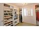 Well-organized closet with shelves for shoes, accessories, and chandelier at 1105 Enderly Ln, Las Vegas, NV 89144