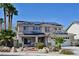 Charming two-story home featuring solar panels, a tile roof, and a desert-landscaped front yard at 1105 Enderly Ln, Las Vegas, NV 89144