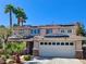 Two-story home with solar panels, a tile roof, and a two-car garage at 1105 Enderly Ln, Las Vegas, NV 89144