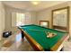 Bright game room with a pool table, plantation shutters, and a decorative mirror at 1105 Enderly Ln, Las Vegas, NV 89144