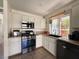 Bright kitchen featuring white cabinets, stainless steel appliances, and a window view at 1105 Enderly Ln, Las Vegas, NV 89144