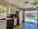 Bright kitchen with stainless steel refrigerator and sliding glass door access to backyard with pool at 1105 Enderly Ln, Las Vegas, NV 89144