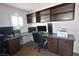 Functional home office with custom built-ins, dark wood cabinets and granite countertops at 1105 Enderly Ln, Las Vegas, NV 89144