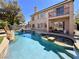 Back of home featuring private backyard swimming pool with waterfall and unique rock accents at 1105 Enderly Ln, Las Vegas, NV 89144