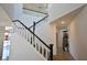 Bright, two-story staircase featuring white banisters and dark wood accents at 1105 Enderly Ln, Las Vegas, NV 89144