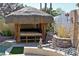 Close-up of a tiki hut featuring seating and decorative elements, ideal for outdoor lounging at 1105 Enderly Ln, Las Vegas, NV 89144