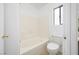 A functional bathroom featuring a bathtub and toilet, offering essential amenities for comfortable living at 11079 Zampino St, Las Vegas, NV 89141