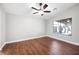 Bedroom with a ceiling fan and large window, providing ample comfort and natural light at 11079 Zampino St, Las Vegas, NV 89141