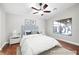 A staged bedroom featuring wood floors, ceiling fan and natural light at 11079 Zampino St, Las Vegas, NV 89141