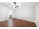 A cozy bedroom boasts dark wood floors and a ceiling fan, offering a comfortable and stylish living space at 11079 Zampino St, Las Vegas, NV 89141