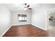 An empty room with wood floors with large windows to the backyard at 11079 Zampino St, Las Vegas, NV 89141