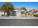 Single-story home with desert landscaping, a two-car garage, and a tile roof at 11079 Zampino St, Las Vegas, NV 89141