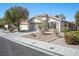 Single-story home with desert landscaping, mature trees, and a two-car garage at 11079 Zampino St, Las Vegas, NV 89141