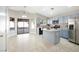 Cozy kitchen featuring stainless appliances, light blue cabinets, and a functional center island at 11079 Zampino St, Las Vegas, NV 89141