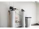 Water softener system installed in garage against white painted wall at 11079 Zampino St, Las Vegas, NV 89141