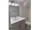 Clean bathroom features gray cabinets, white marble-look countertops and tile in the tub/shower at 1203 Mews Ln, Las Vegas, NV 89101