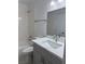 Clean bathroom features gray cabinets, white marble-look countertops and tile in the tub/shower at 1203 Mews Ln, Las Vegas, NV 89101