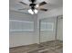 Bedroom features mirrored closet doors, wood floors and a ceiling fan with lighting at 1203 Mews Ln, Las Vegas, NV 89101