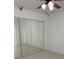 Bright bedroom with large mirrored closet and neutral flooring, enhanced by a ceiling fan at 1203 Mews Ln, Las Vegas, NV 89101