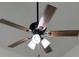 Close-up of a ceiling fan with multiple lights and wooden blades at 1203 Mews Ln, Las Vegas, NV 89101