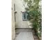 View of a charming courtyard area with a window with security bars and some greenery at 1203 Mews Ln, Las Vegas, NV 89101