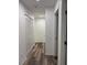 Hallway view with wood-look floors, white doors, and closet at 1203 Mews Ln, Las Vegas, NV 89101
