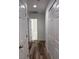 Hallway view with wood-look floors, white doors, and storage at 1203 Mews Ln, Las Vegas, NV 89101