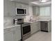 Modern kitchen features stainless steel appliances, gray cabinets, and a white marble-look countertop at 1203 Mews Ln, Las Vegas, NV 89101