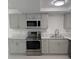 Beautiful, updated kitchen boasts stainless appliances, stone countertops, and stylish gray cabinets at 1203 Mews Ln, Las Vegas, NV 89101