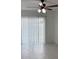 Bright living room features tile flooring, a ceiling fan, and sliding door access to the backyard at 1203 Mews Ln, Las Vegas, NV 89101