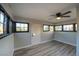 This bright room features many windows, new flooring, and modern ceiling fan and fixtures at 170 Copper St, Henderson, NV 89015