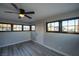 Bright room features many windows, new flooring, and modern ceiling fan and fixtures at 170 Copper St, Henderson, NV 89015