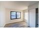 Bright bedroom with gray wood-look flooring and a sliding-door closet at 170 Copper St, Henderson, NV 89015