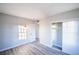 Bedroom featuring gray wood-look floors, window, closet, and neutral walls at 170 Copper St, Henderson, NV 89015