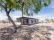 Angle view of gray home, featuring low-maintenance landscaping and carport at 170 Copper St, Henderson, NV 89015