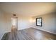 Bright living room with gray wood-look flooring and a black-framed window offering natural light at 170 Copper St, Henderson, NV 89015