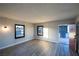 Living room showcasing gray wood-look floors, and windows for natural light and fresh air at 170 Copper St, Henderson, NV 89015