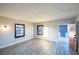 Living room showcasing gray wood-look floors, and windows for natural light and fresh air at 170 Copper St, Henderson, NV 89015