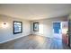 Living room showcasing gray wood-look floors, and windows for natural light and fresh air at 170 Copper St, Henderson, NV 89015