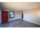 Inviting living room features wood-look flooring, neutral walls, and a bright red front door at 170 Copper St, Henderson, NV 89015