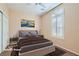 This staged bedroom offers a neutral color palette and shuttered window at 2167 Shadow Canyon Dr, Henderson, NV 89044