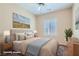 This staged bedroom features a ceiling fan, shuttered window, and natural light at 2167 Shadow Canyon Dr, Henderson, NV 89044