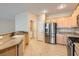 Modern kitchen featuring stainless steel appliances, granite countertops, and tile floors at 2167 Shadow Canyon Dr, Henderson, NV 89044