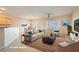 Inviting living space with modern furniture, plantation shutters, and an open layout to dining area at 2167 Shadow Canyon Dr, Henderson, NV 89044