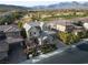Stunning aerial view of a home on a golf course with mature landscaping and mountain views at 2215 Alcova Ridge Dr, Las Vegas, NV 89135