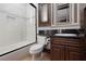 Well lit bathroom featuring decorative tile detail, black granite countertop and white fixtures at 2215 Alcova Ridge Dr, Las Vegas, NV 89135