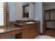 Bathroom vanity features marble countertops, dark cabinets, and view into walk-in closet at 2215 Alcova Ridge Dr, Las Vegas, NV 89135
