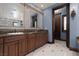 Spacious bathroom vanity with ample counter space, cabinets, and access to a well-lit walk-in closet at 2215 Alcova Ridge Dr, Las Vegas, NV 89135