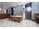 Well-lit bathroom with soaking tub, glass block window, and walk-in glass shower at 2215 Alcova Ridge Dr, Las Vegas, NV 89135